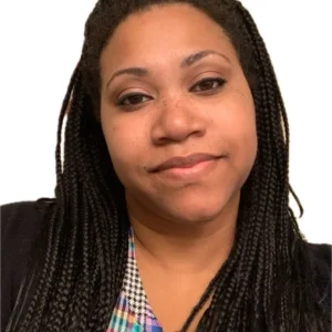 A woman with braids wearing a black jacket.