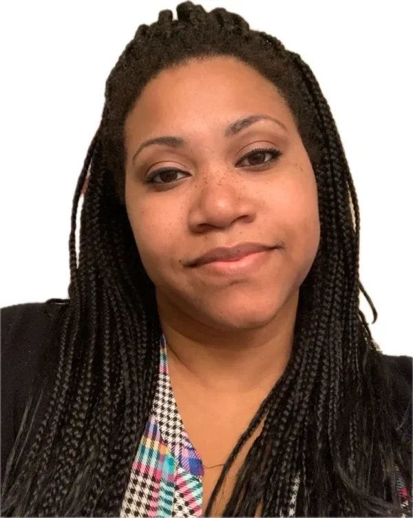 A woman with braids wearing a black jacket.